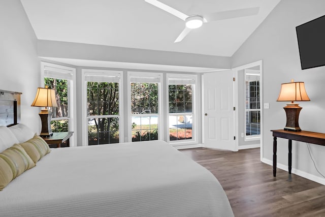 bedroom featuring a ceiling fan, baseboards, wood finished floors, and lofted ceiling