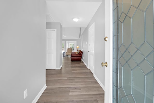 foyer featuring baseboards and wood finished floors