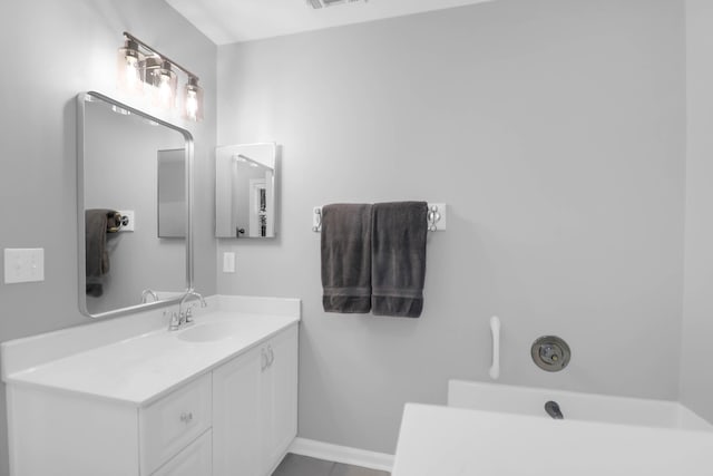 bathroom with vanity, baseboards, and visible vents