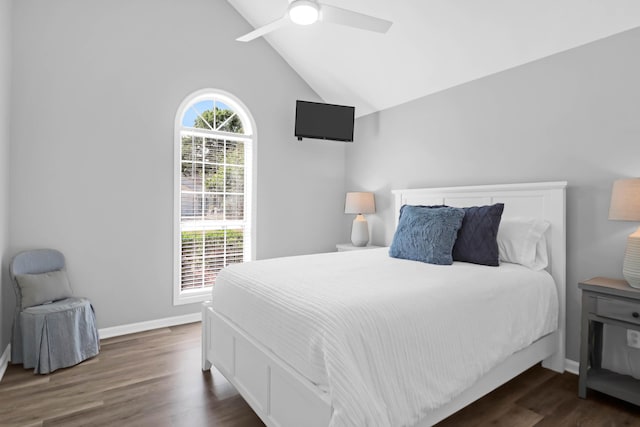 bedroom with baseboards, ceiling fan, wood finished floors, and lofted ceiling