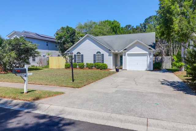 single story home featuring an attached garage, fence, driveway, and a front yard