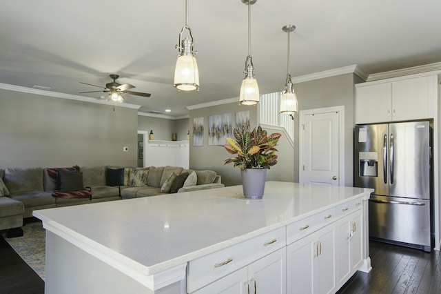 kitchen with a center island, white cabinets, decorative light fixtures, and stainless steel refrigerator with ice dispenser