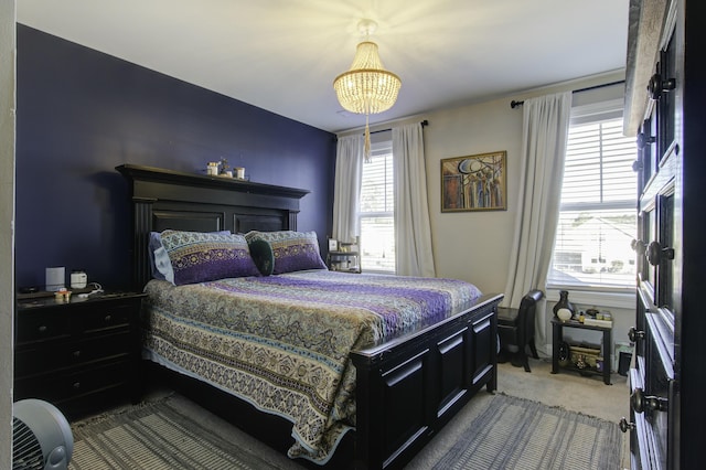 bedroom featuring a notable chandelier and carpet floors