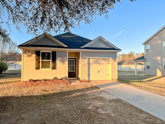 view of front of home featuring a garage and a front lawn