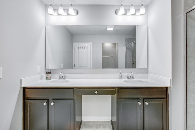 bathroom with vanity and a shower with door