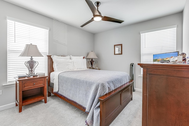 bedroom with ceiling fan and light carpet