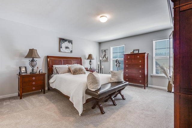 carpeted bedroom featuring multiple windows