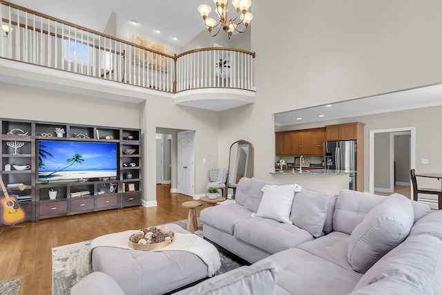 591 Two Mile Run, Johns Island, SC 29455 - living room featuring a high ceiling, a chandelier, light wood finished floors, and recessed lighting