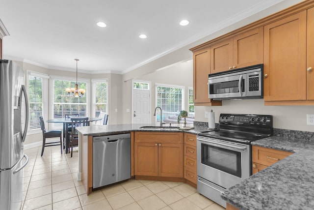 591 Two Mile Run, Johns Island, SC 29455 - kitchen with appliances with stainless steel finishes, a chandelier, a peninsula, brown cabinets, and ornamental molding