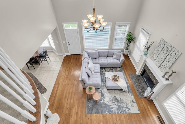 591 Two Mile Run, Johns Island, SC 29455 - living area featuring a chandelier, a high ceiling, wood finished floors, and a fireplace