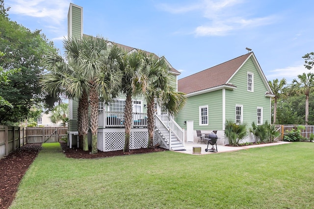 591 Two Mile Run, Johns Island, SC 29455 - back of property with a fenced backyard, a patio area, stairs, a chimney, and a shingled roof