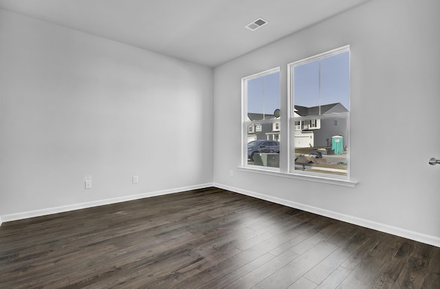 spare room featuring dark hardwood / wood-style floors