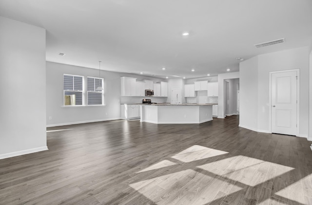 unfurnished living room featuring dark hardwood / wood-style flooring and sink