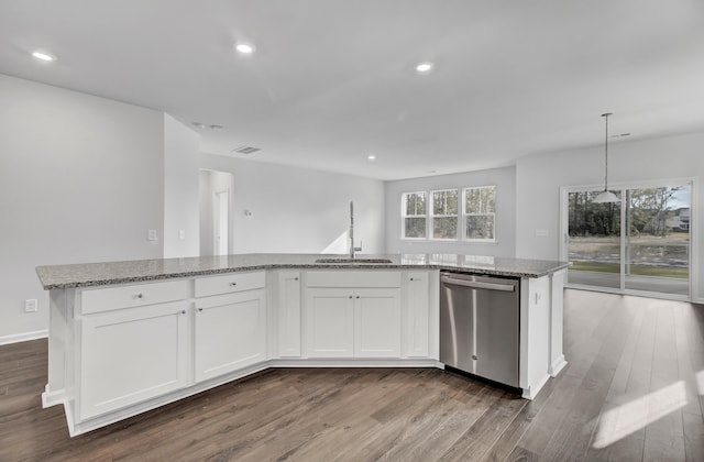 kitchen featuring sink, stainless steel dishwasher, white cabinets, and a center island with sink