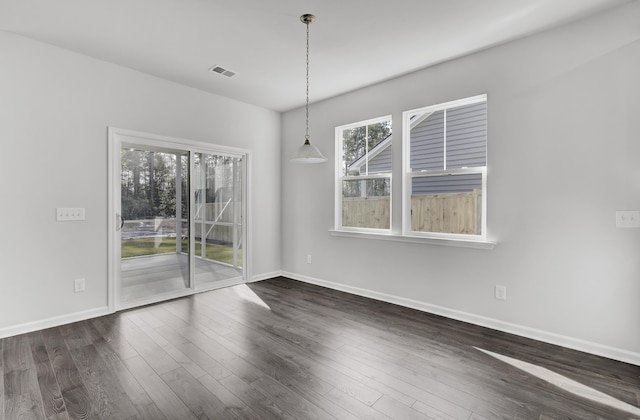 empty room with dark wood-type flooring