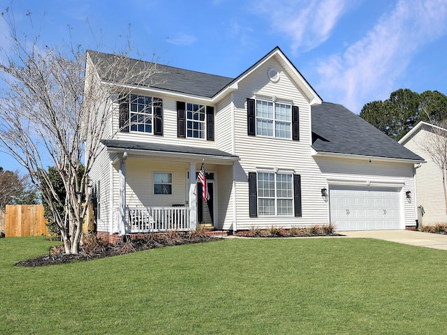 traditional home featuring a front lawn, an attached garage, covered porch, and driveway