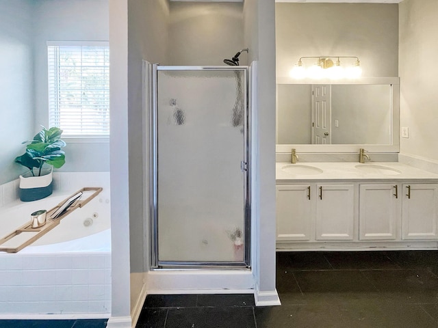 bathroom featuring a bath, a shower stall, and a sink