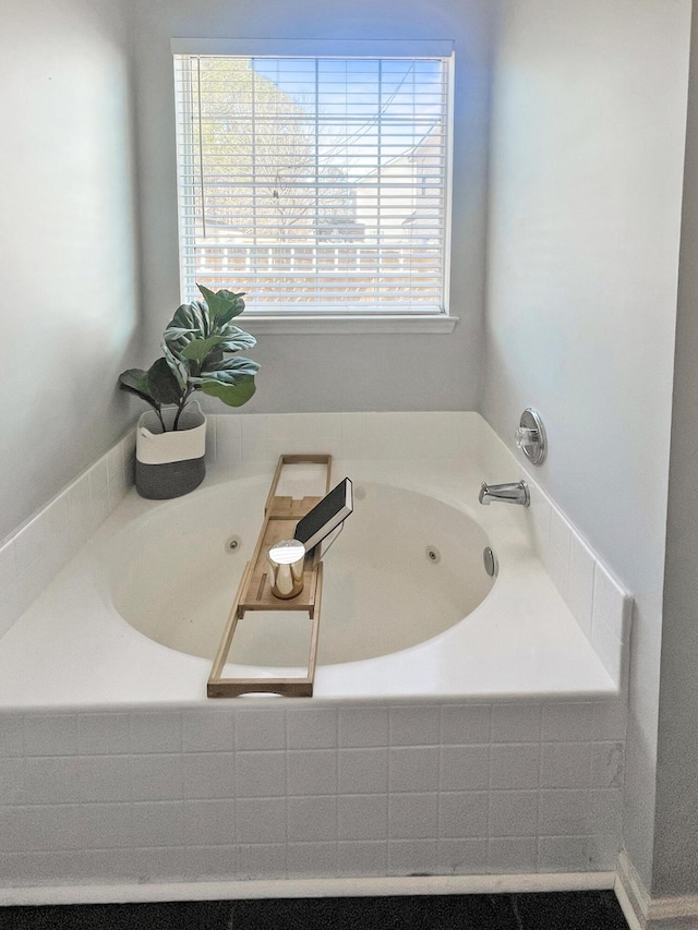 bathroom featuring a tub with jets