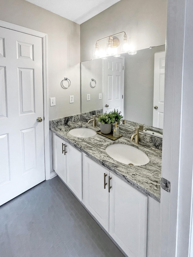 full bath with double vanity and a sink