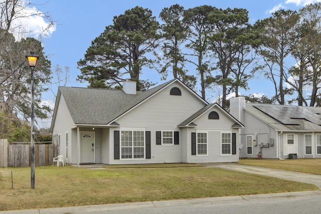 view of front of property featuring a chimney, a front yard, and fence