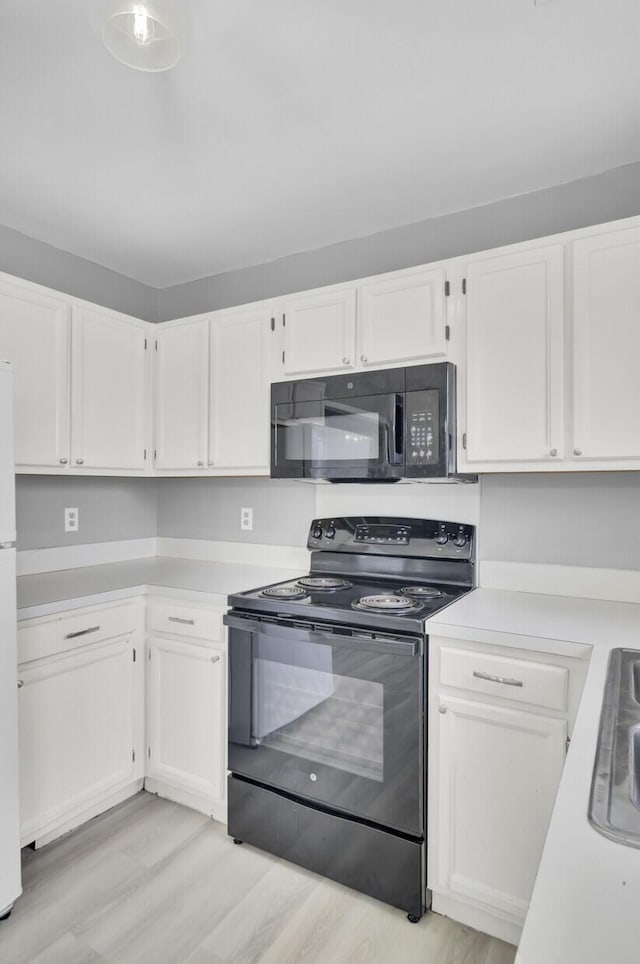 kitchen with black appliances, light wood-style flooring, light countertops, and white cabinetry