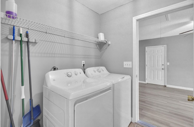 washroom featuring washer and clothes dryer, attic access, wood finished floors, laundry area, and baseboards