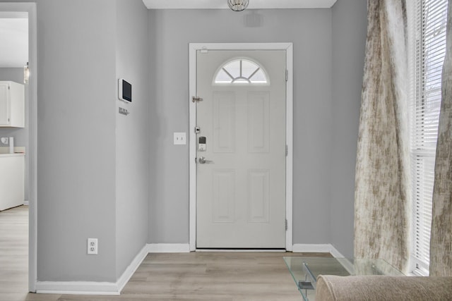 entryway featuring light wood-type flooring and baseboards