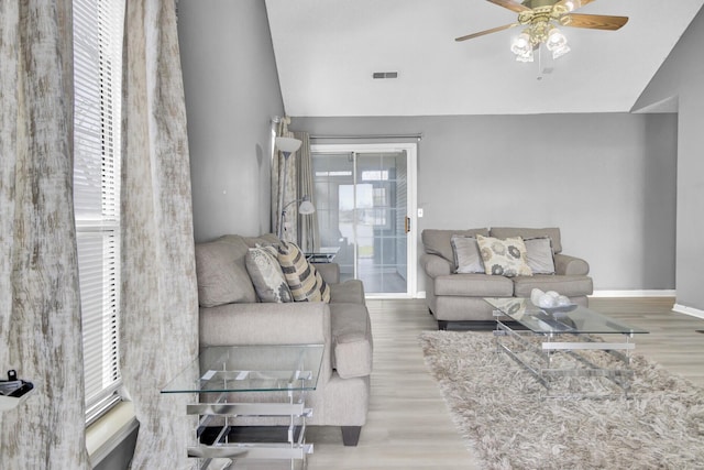 living room featuring ceiling fan, vaulted ceiling, and wood finished floors