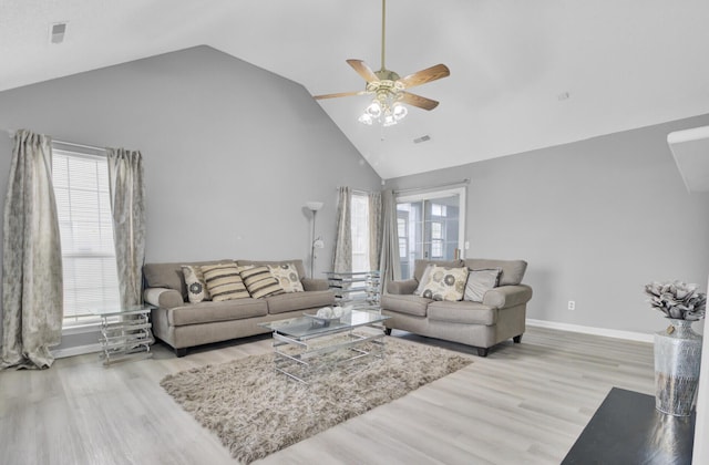 living area featuring high vaulted ceiling, visible vents, light wood-style floors, and a ceiling fan