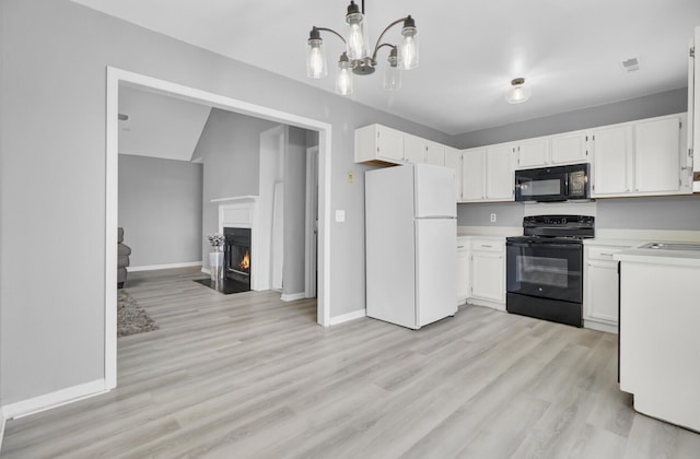 kitchen featuring a fireplace with flush hearth, baseboards, light countertops, light wood-type flooring, and black appliances