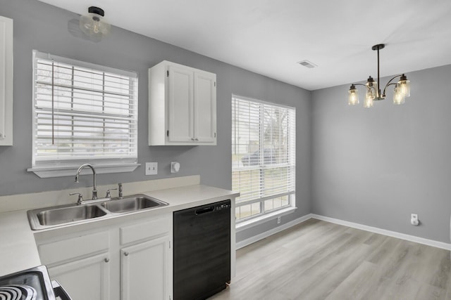 kitchen with light wood finished floors, black dishwasher, light countertops, white cabinetry, and a sink