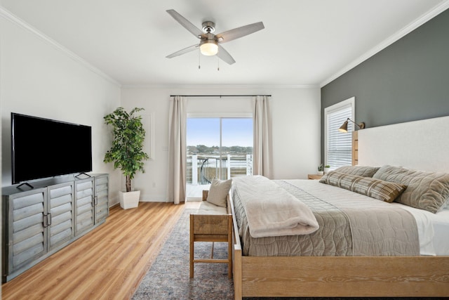 bedroom featuring wood finished floors, a ceiling fan, baseboards, access to exterior, and ornamental molding