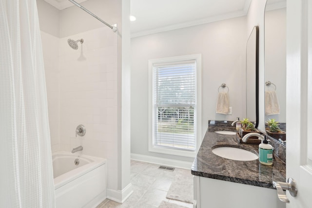 bathroom featuring a sink, visible vents, baseboards, shower / bath combo, and crown molding