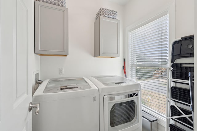 washroom with washing machine and dryer and cabinet space