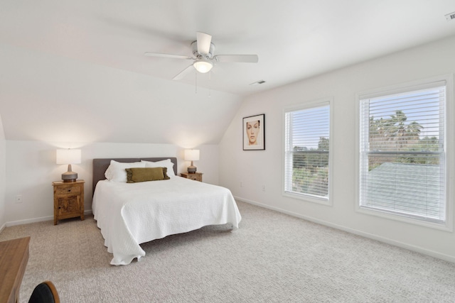 carpeted bedroom with lofted ceiling, a ceiling fan, visible vents, and baseboards