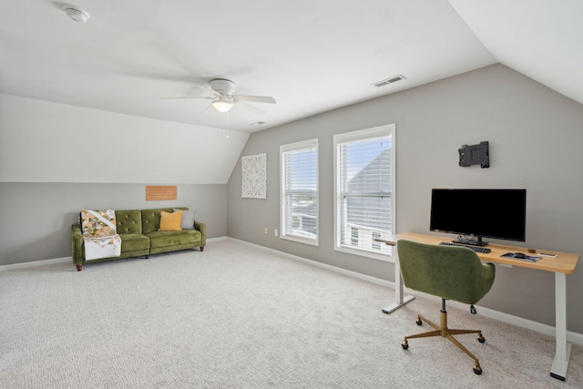 carpeted office space with visible vents, vaulted ceiling, baseboards, and ceiling fan