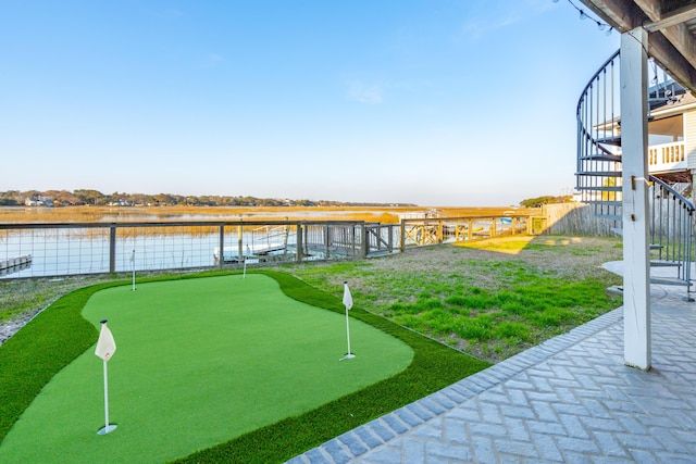 surrounding community featuring stairway, a water view, and fence