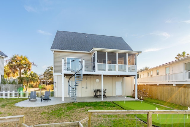 back of property featuring a yard, stairway, a sunroom, a patio area, and a fenced backyard