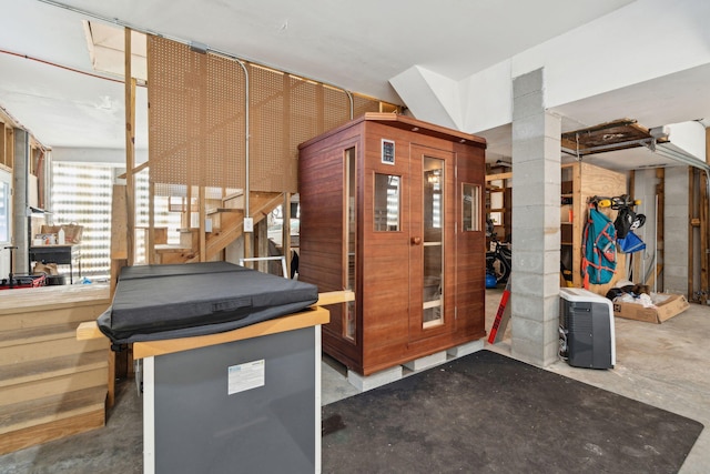 recreation room with unfinished concrete floors