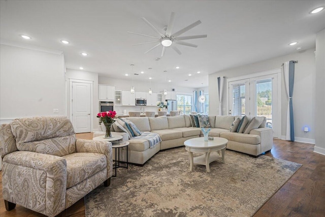 living room featuring ceiling fan and dark hardwood / wood-style floors