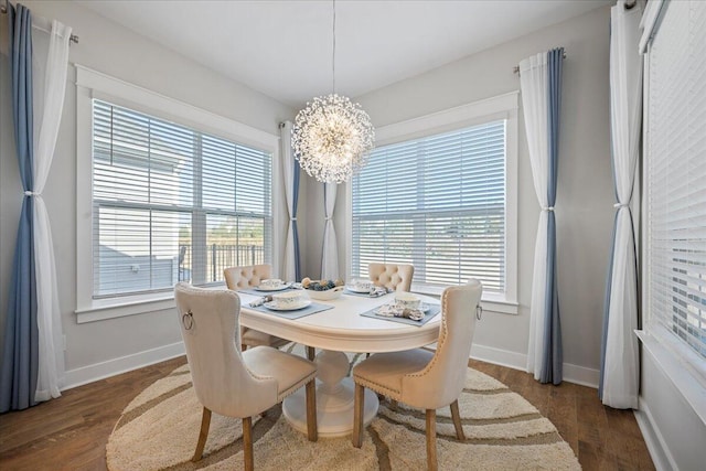 dining space with a notable chandelier, a wealth of natural light, and dark hardwood / wood-style floors