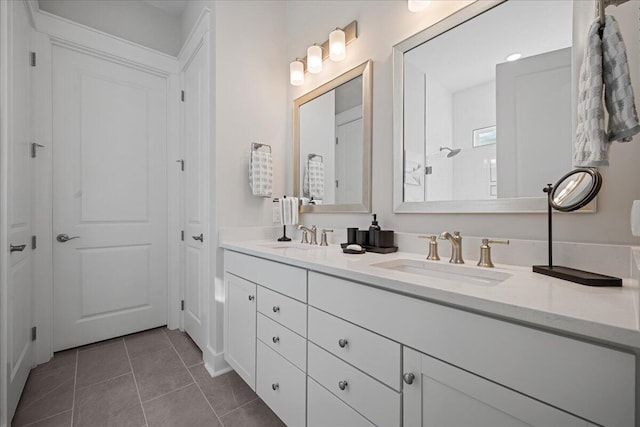 bathroom with a shower, vanity, and tile patterned flooring