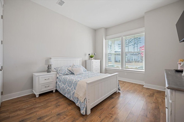 bedroom with dark wood-type flooring