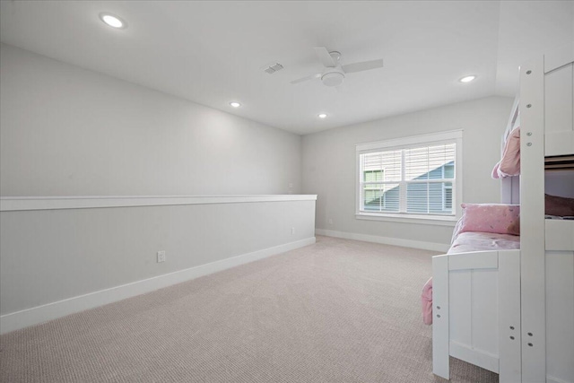 unfurnished bedroom featuring light colored carpet and ceiling fan