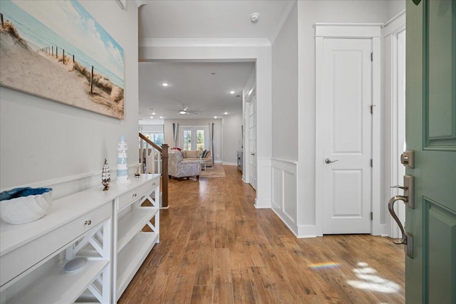 foyer with light wood-type flooring, ceiling fan, and french doors