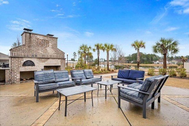 view of patio featuring an outdoor living space with a fireplace