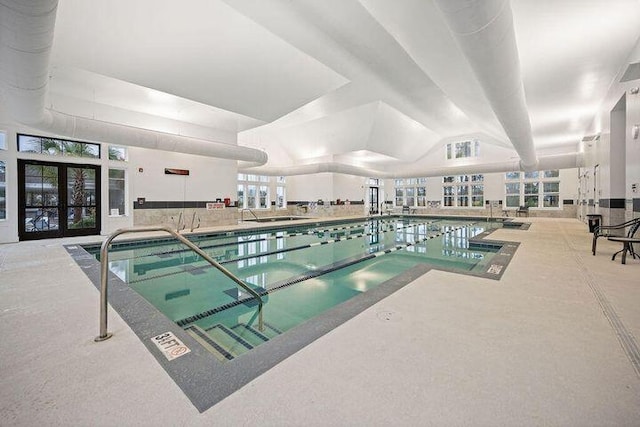 view of swimming pool featuring french doors