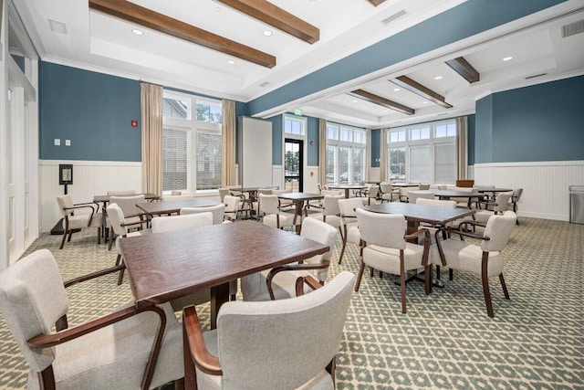 dining space with beamed ceiling, crown molding, and carpet flooring