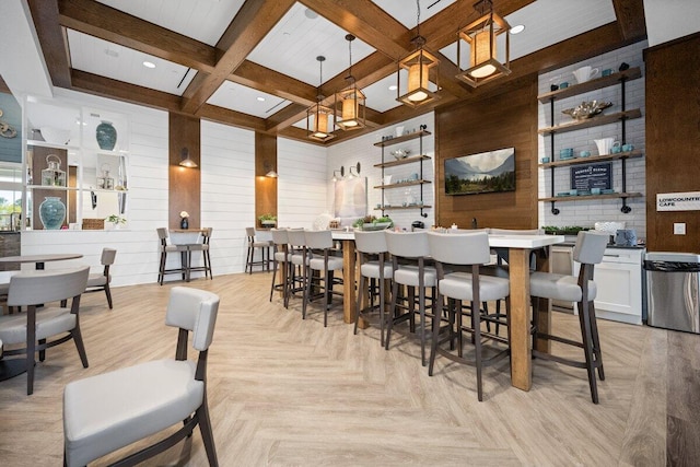 dining room featuring beamed ceiling, light parquet floors, wooden walls, and coffered ceiling