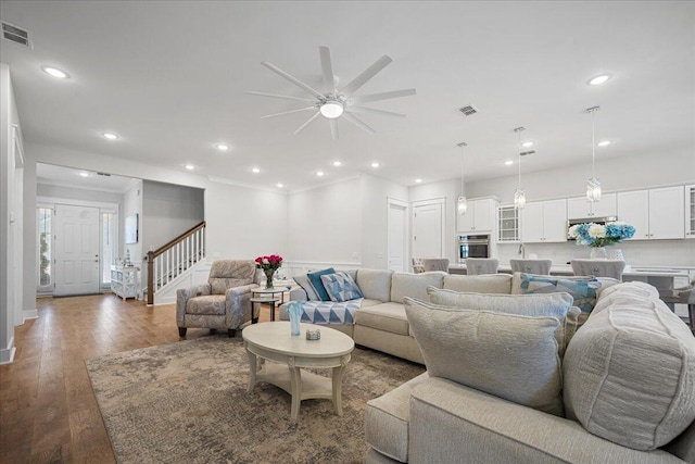 living room featuring ceiling fan and hardwood / wood-style floors